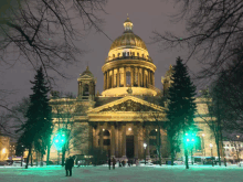 a large building is lit up at night with a dome