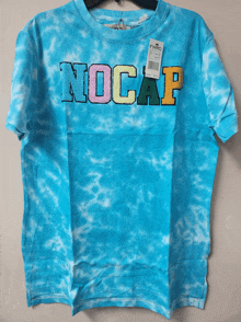 a blue tie dye t-shirt with the word nocap embroidered on it