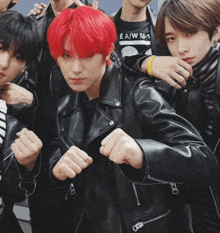 a group of young men are posing for a picture and one has red hair .