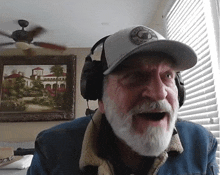 a man with a beard wearing headphones and a hat that says ' california ' on it