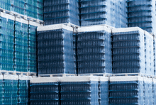 stacks of blue plastic bottles are wrapped in plastic and stacked on top of each other