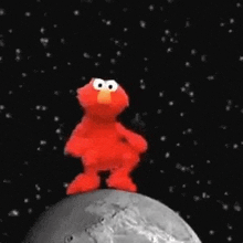 elmo from sesame street is standing on top of a moon in the space .