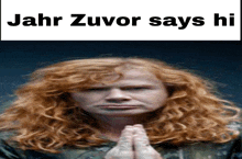 a red haired man with his hands folded and the words jahr zuvor says hi above him