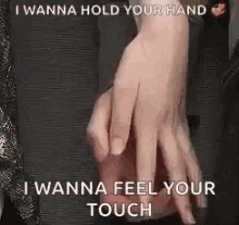 a couple holding hands with the words `` i wanna hold your hand i wanna feel your touch '' written on it .