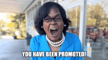 a woman in a blue shirt and pearls is screaming with the words you have been promoted written below her