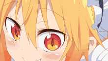 a close up of a girl 's eyes with red and yellow