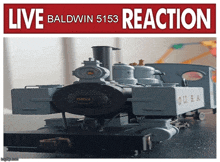 a picture of a model train with the words live baldwin 5153 reaction above it