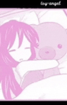 a girl is sleeping with a teddy bear in her arms .