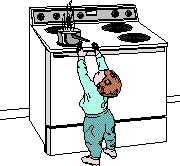 a child is reaching for a pot on a stove top