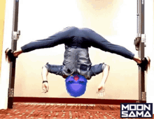 a person doing a handstand in front of a sign that says moon sama on it