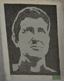 a black and white drawing of a man 's face on a piece of paper