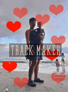 a picture of a man holding a child on a beach with the words track maker in the corner