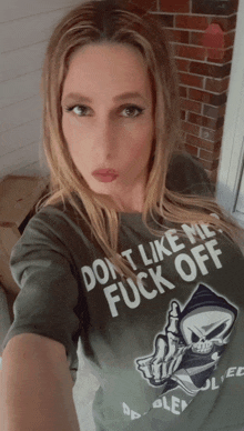 a woman is wearing a t-shirt that says " do n't like me fuck off "