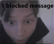 a blurred image of a person with the words 1 blocked message above them