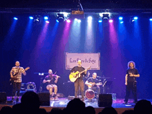 a band on stage with a sign that says les fils du roy on it