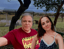 a man and a woman are posing for a picture and the man is wearing a pure t-shirt