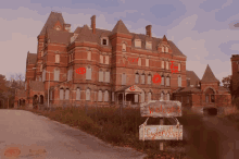 a large red brick building with a sign that says welcome