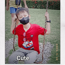 a young boy wearing a face mask is sitting on a swing with the word cute written on the bottom