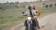 a man and a woman are riding a motorcycle with a license plate that says raj iw u 2140