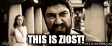 a man with a beard is standing in front of a woman and says `` this is ziost ! ''