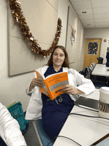 a woman in a lab coat is reading a book about rapid interpretation