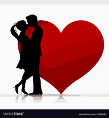 a man and woman kissing in front of a red heart