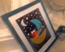 a framed picture of elmo sleeping on a moon