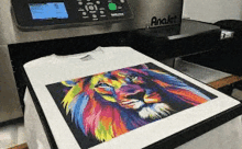 a t-shirt with a colorful lion on it is being printed on a machine .