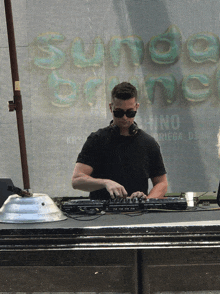 a man is playing music in front of a sign that says sundae brunch