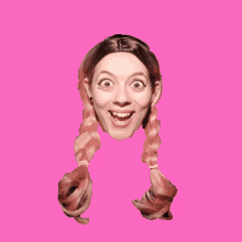 a woman with pigtails on a pink background makes a surprised face