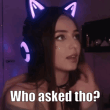 a woman wearing headphones with cat ears and the words who asked tho