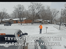 a man is standing in the snow near a mailbox with the words trying to put out the garbage this moring