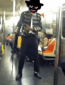 a man with a mask on his face is on a subway train