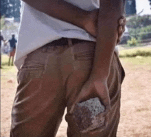 a person is holding a large rock in their hand .