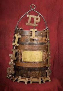 a wooden barrel with chains around it and the letter i on it .