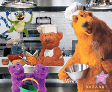 a group of stuffed animals are standing in a kitchen and one bear is wearing a chef 's hat and holding a bowl