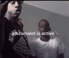 a group of young men are standing next to each other in a room with the words `` atkcumalot is active '' .