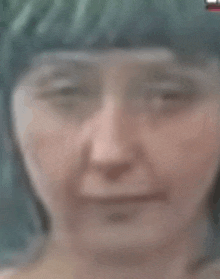 a close up of a woman 's face with a blurred background