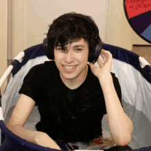 a young man wearing headphones is sitting in a bath tub