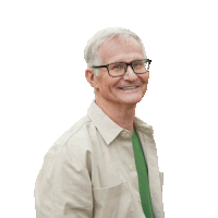 an older man wearing glasses and a green shirt smiles