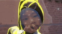 a girl wearing a yellow hoodie with butterflies on her face is covering her mouth .