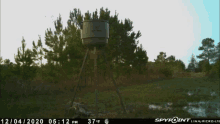 a spypoint camera shows a tower in the middle of a field