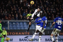 a soccer player is jumping in the air to catch a soccer ball during a soccer game .