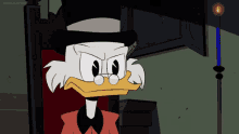 a cartoon duck with a top hat and glasses is sitting in a chair with a candle in front of him