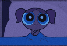 bubbles from the powerpuff girls is laying in a bed with a blue blanket .