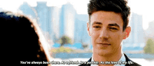 a man in a suit is talking to a woman in front of a city skyline .