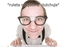 a man with glasses and a bandage on his nose is typing