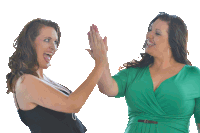 two women are giving each other a high five and one of them is wearing a green dress