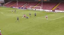 a soccer game is being played in an empty stadium with ads for rainham steel coleman electricala ams and sky bet