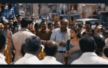 a crowd of people are gathered on a busy street with a man wearing a hat that says ' apollo '